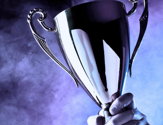 Hand Holding Trophy
